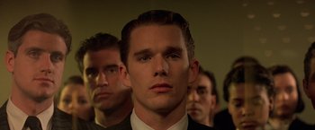 Movie still from “Gattaca” (1997), directed by Andrew Niccol – A group of men standing next to each other in a room; Close Up shot, Over the shoulder angle