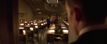 Movie still from “Gattaca” (1997), directed by Andrew Niccol – A group of people standing in a room with lights on; Wide shot, High angle