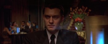 Movie still from “Gattaca” (1997), directed by Andrew Niccol – A person wearing a suit and tie; Close Up shot, Low angle
