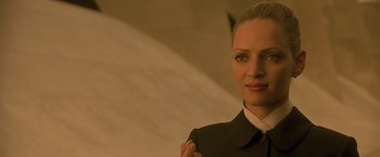 Movie still from “Gattaca” (1997), directed by Andrew Niccol – A woman wearing a suit and a white tie; Close Up shot, Low angle