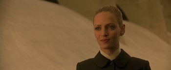 Movie still from “Gattaca” (1997), directed by Andrew Niccol – A woman with blonde hair wearing a black suit; Close Up shot, Low angle