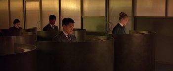 Movie still from “Gattaca” (1997), directed by Andrew Niccol – A group of men in suits and ties in a room; Wide shot, High angle