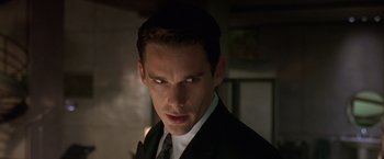 Movie still from “Gattaca” (1997), directed by Andrew Niccol – A person wearing a suit and tie; Close Up shot, Low angle