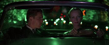 Movie still from “Gattaca” (1997), directed by Andrew Niccol – A man and a woman sitting in the back of a car; Medium shot, Low angle