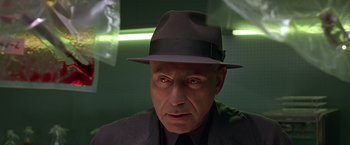 Movie still from “Gattaca” (1997), directed by Andrew Niccol – An older man wearing a hat and a suit; Close Up shot, Low angle