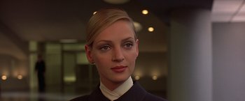 Movie still from “Gattaca” (1997), directed by Andrew Niccol – A woman in a black jacket and a white shirt; Close Up shot, Low angle
