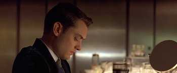 Movie still from “Gattaca” (1997), directed by Andrew Niccol – A person wearing a suit and tie; Close Up shot, Low angle