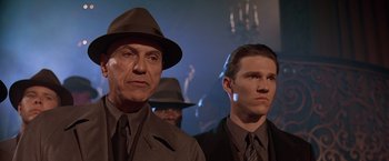 Movie still from “Gattaca” (1997), directed by Andrew Niccol – A man and a man in a suit and tie; Close Up shot, Low angle