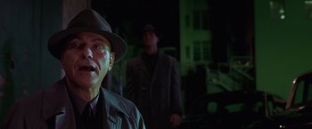 Movie still from “Gattaca” (1997), directed by Andrew Niccol – A man in a hat and a suit standing next to another man in a suit; Close Up shot, Low angle