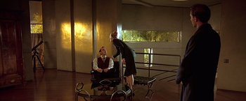 Movie still from “Gattaca” (1997), directed by Andrew Niccol – A man and a woman sitting in a room; Wide shot, Low angle
