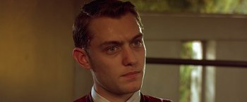 Movie still from “Gattaca” (1997), directed by Andrew Niccol – A person wearing a suit and tie; Close Up shot, Low angle