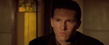 Movie still from “Gattaca” (1997), directed by Andrew Niccol – A person wearing a suit and tie; Close Up shot, Low angle
