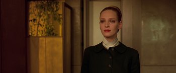Movie still from “Gattaca” (1997), directed by Andrew Niccol – A woman with red hair wearing a black jacket; Close Up shot, Low angle