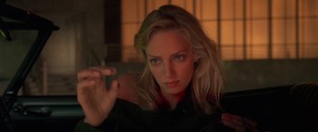 Movie still from “Gattaca” (1997), directed by Andrew Niccol – A beautiful blonde woman with a cigarette in her hand; Close Up shot, Over the shoulder angle