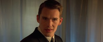 Movie still from “Gattaca” (1997), directed by Andrew Niccol – A man in a black suit and white tie; Close Up shot, Low angle