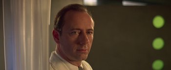 Movie still from “Gattaca” (1997), directed by Andrew Niccol – A person wearing a white shirt; Close Up shot, Low angle