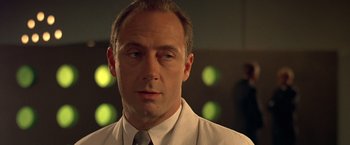 Movie still from “Gattaca” (1997), directed by Andrew Niccol – A person wearing a suit and tie; Close Up shot, Low angle