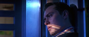 Movie still from “Gattaca” (1997), directed by Andrew Niccol – A man's face with a blue background; Close Up shot, Low angle
