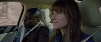 Movie still from “Get Out” (2017), directed by Jordan Peele – A man and a woman sitting in the back of a car; Close Up shot, Over the shoulder angle