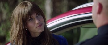 Movie still from “Get Out” (2017), directed by Jordan Peele – A beautiful young lady sitting in front of a motorcycle; Close Up shot, Over the shoulder angle