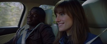Movie still from “Get Out” (2017), directed by Jordan Peele – A man and a woman sitting in the back of a car; Close Up shot, Over the shoulder angle