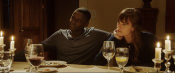 Movie still from “Get Out” (2017), directed by Jordan Peele – A man and a woman sitting at a dinner table; Medium shot, Over the shoulder angle