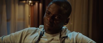 Movie still from “Get Out” (2017), directed by Jordan Peele – A person wearing a hoodie; Close Up shot, High angle