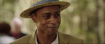 Movie still from “Get Out” (2017), directed by Jordan Peele – A person wearing a hat; Close Up shot, Over the shoulder angle