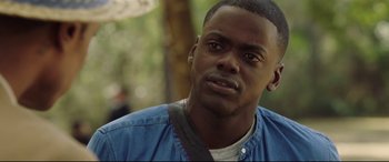 Movie still from “Get Out” (2017), directed by Jordan Peele – A person wearing a blue shirt; Close Up shot, Over the shoulder angle
