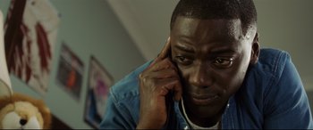Movie still from “Get Out” (2017), directed by Jordan Peele – A person talking on a cell phone; Close Up shot, High angle