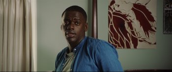 Movie still from “Get Out” (2017), directed by Jordan Peele – A person wearing a blue shirt; Close Up shot, Over the shoulder angle
