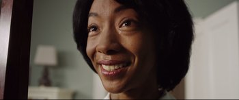 Movie still from “Get Out” (2017), directed by Jordan Peele – A person with a smile on their face; Close Up shot, High angle