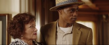 Movie still from “Get Out” (2017), directed by Jordan Peele – A man and a woman standing next to each other; Close Up shot, Over the shoulder angle