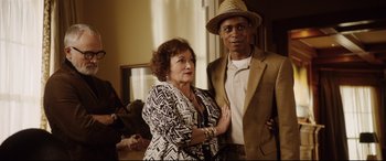 Movie still from “Get Out” (2017), directed by Jordan Peele – A man and a woman standing next to each other in a room; Medium shot, Over the shoulder angle