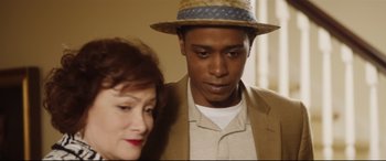 Movie still from “Get Out” (2017), directed by Jordan Peele – A man and a woman standing next to each other in a room; Close Up shot, Over the shoulder angle