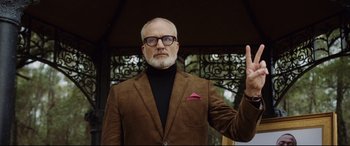 Movie still from “Get Out” (2017), directed by Jordan Peele – An older man in a brown jacket and a black sweater; Medium shot, Low angle