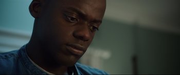 Movie still from “Get Out” (2017), directed by Jordan Peele – A person with a tie; Close Up shot, Over the shoulder angle