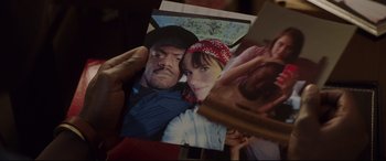 Movie still from “Get Out” (2017), directed by Jordan Peele – A man holding a picture of a woman with a bandage on her head; Extreme Close Up shot, Overhead angle