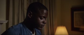 Movie still from “Get Out” (2017), directed by Jordan Peele – A person looking down at his face; Close Up shot, Over the shoulder angle