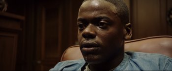 Movie still from “Get Out” (2017), directed by Jordan Peele – A man's face in a chair; Close Up shot, Over the shoulder angle