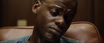 Movie still from “Get Out” (2017), directed by Jordan Peele – A person with his eyes closed; Close Up shot, High angle