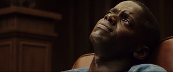 Movie still from “Get Out” (2017), directed by Jordan Peele – A man's face with his eyes closed; Close Up shot, High angle