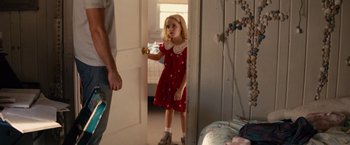 Movie still from “Gifted” (2017), directed by Marc Webb – A little girl in a red dress standing next to a man; Medium shot, Over the shoulder angle