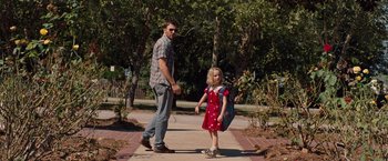 Movie still from “Gifted” (2017), directed by Marc Webb – A man and a little girl walking down a sidewalk; Wide shot, Over the shoulder angle