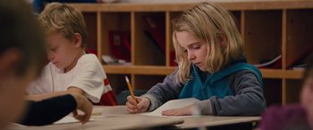 Movie still from “Gifted” (2017), directed by Marc Webb – A girl is writing on a piece of paper; Medium shot, Over the shoulder angle