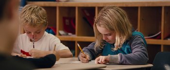 Movie still from “Gifted” (2017), directed by Marc Webb – A girl writing on a piece of paper; Close Up shot, Over the shoulder angle