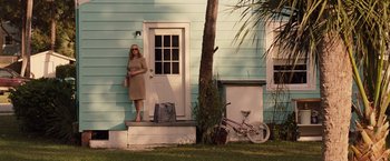 Movie still from “Gifted” (2017), directed by Marc Webb – A woman standing on the front steps of a house; Wide shot, Low angle