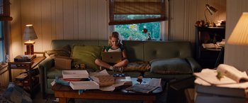 Movie still from “Gifted” (2017), directed by Marc Webb – A girl sitting on a couch using a laptop; Wide shot, High angle
