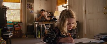Movie still from “Gifted” (2017), directed by Marc Webb – A young girl writing on a piece of paper; Medium shot, Over the shoulder angle