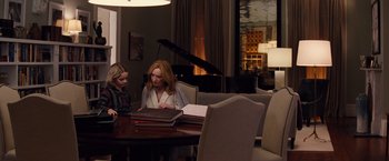 Movie still from “Gifted” (2017), directed by Marc Webb – Two women sitting at a table with papers and a piano; Medium shot, Over the shoulder angle
